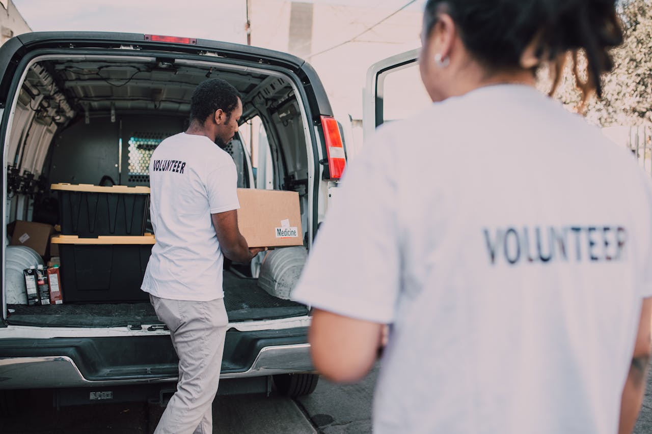 our-services-2 Volunteers loading medicine supplies into a van for donation and distribution.