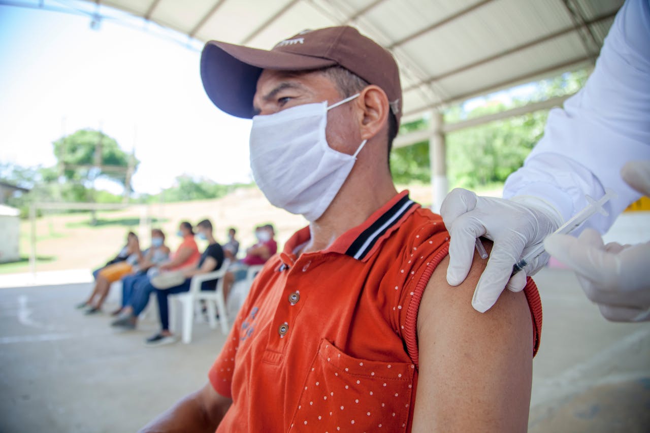 our-services-1 Man receives COVID-19 vaccine in outdoor clinic in Bolívar, Colombia.